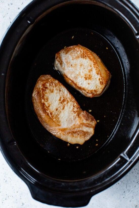 Transfer pork to slow cooker.