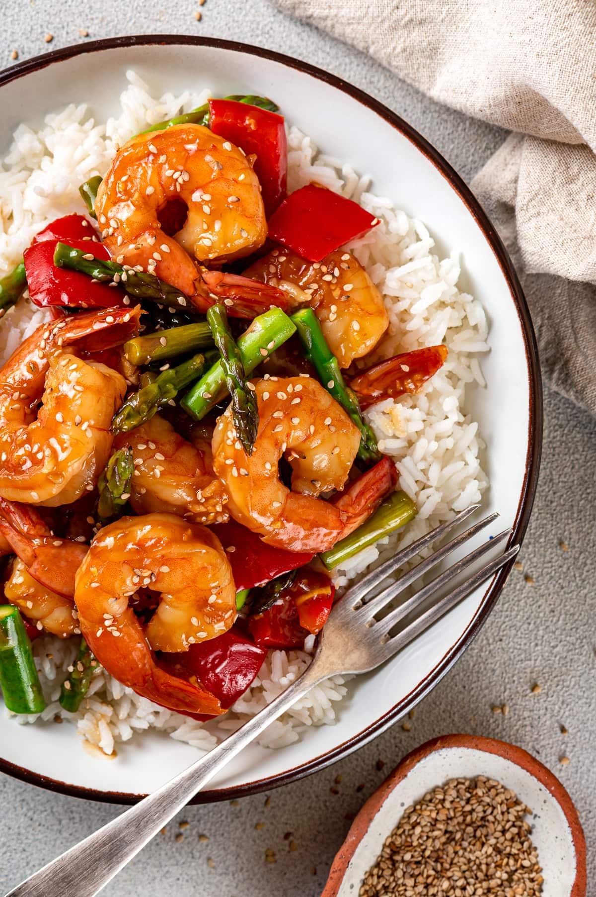 Shrimp Stir Fry over rice with a fork.