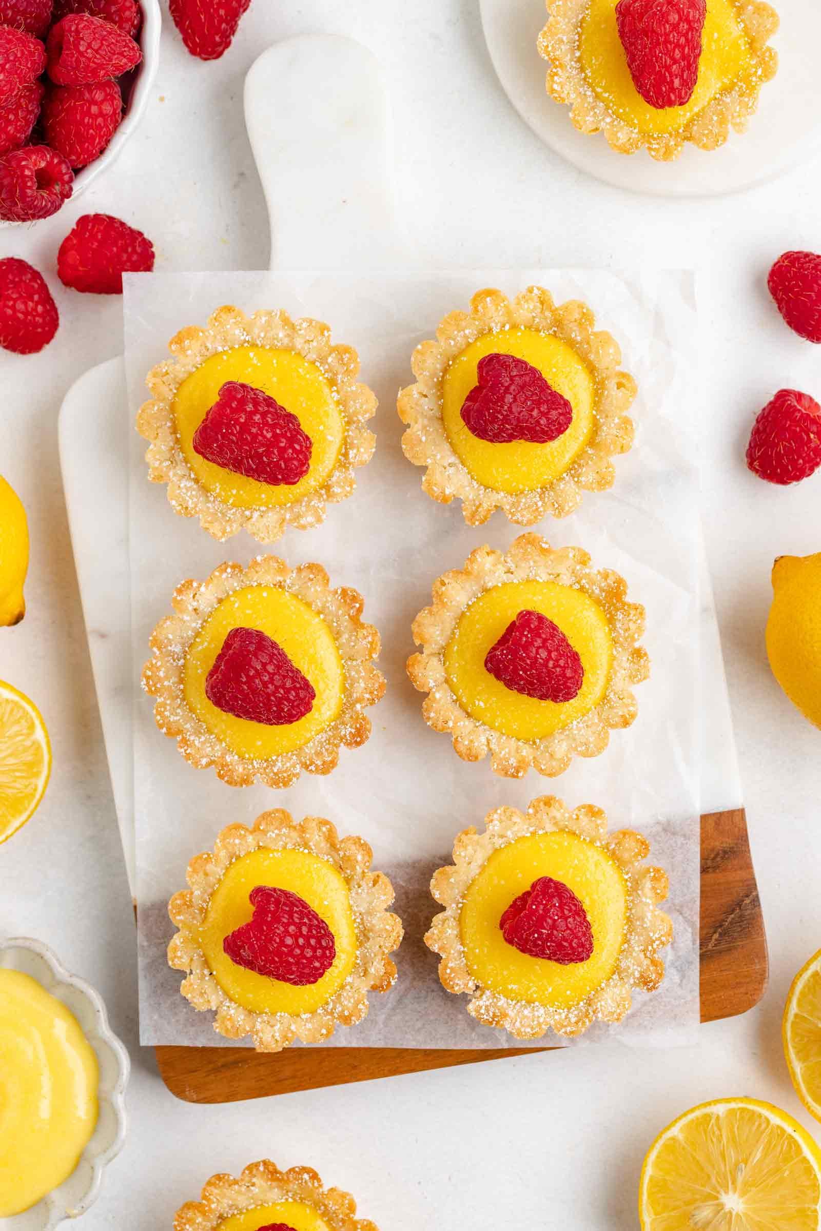 6 lemon tartlets on a cutting board