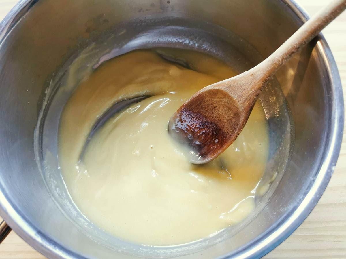 A roux of melted butter and flour in saucepan.