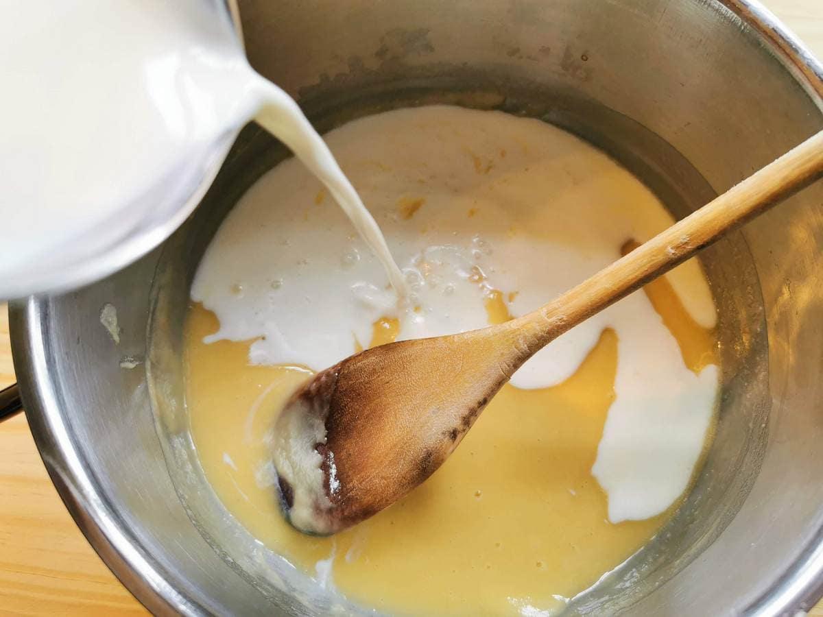 Milk being added to roux to make béchamel.