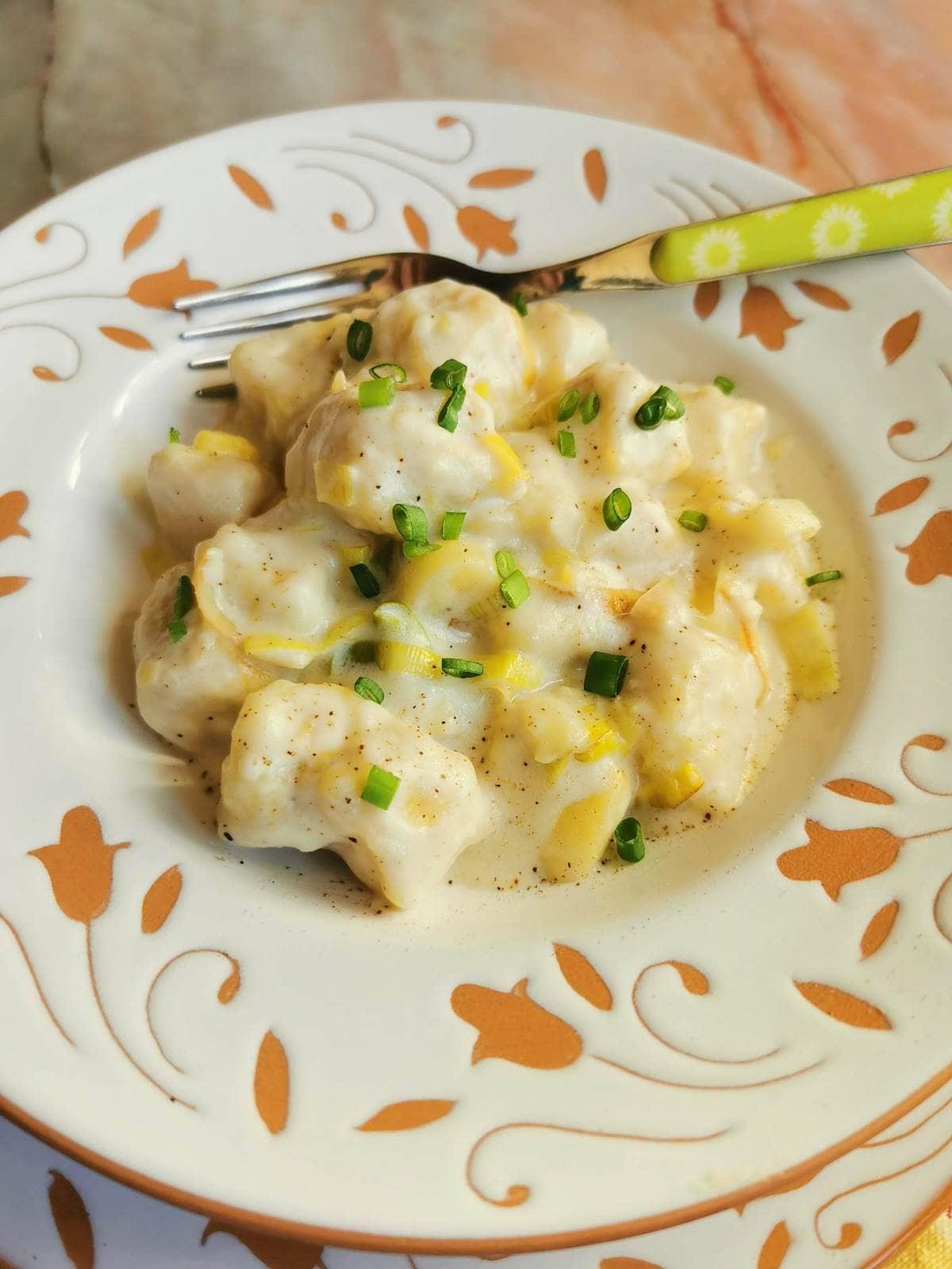 Italian homemade potato gnocchi with cheese and leeks.
