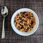 homemade raisin bran in white bowl with spoon