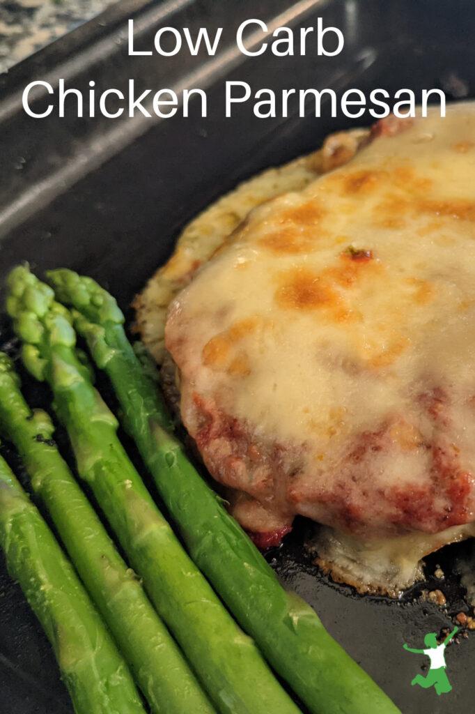 low carb chicken parmesan with grain-free breading and asparagus in baking pan