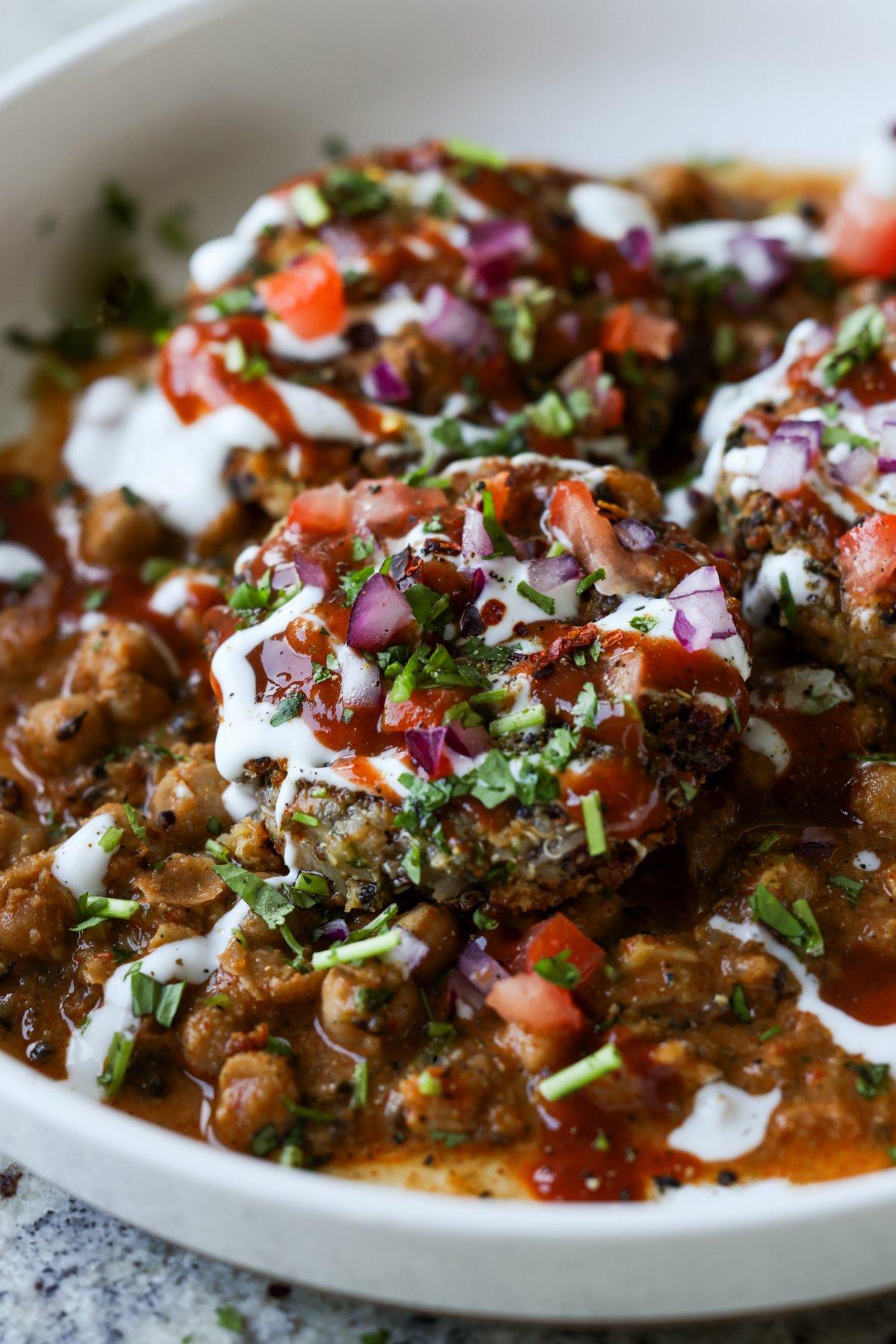 close-up of tikki chole in a bowl after adding toppings