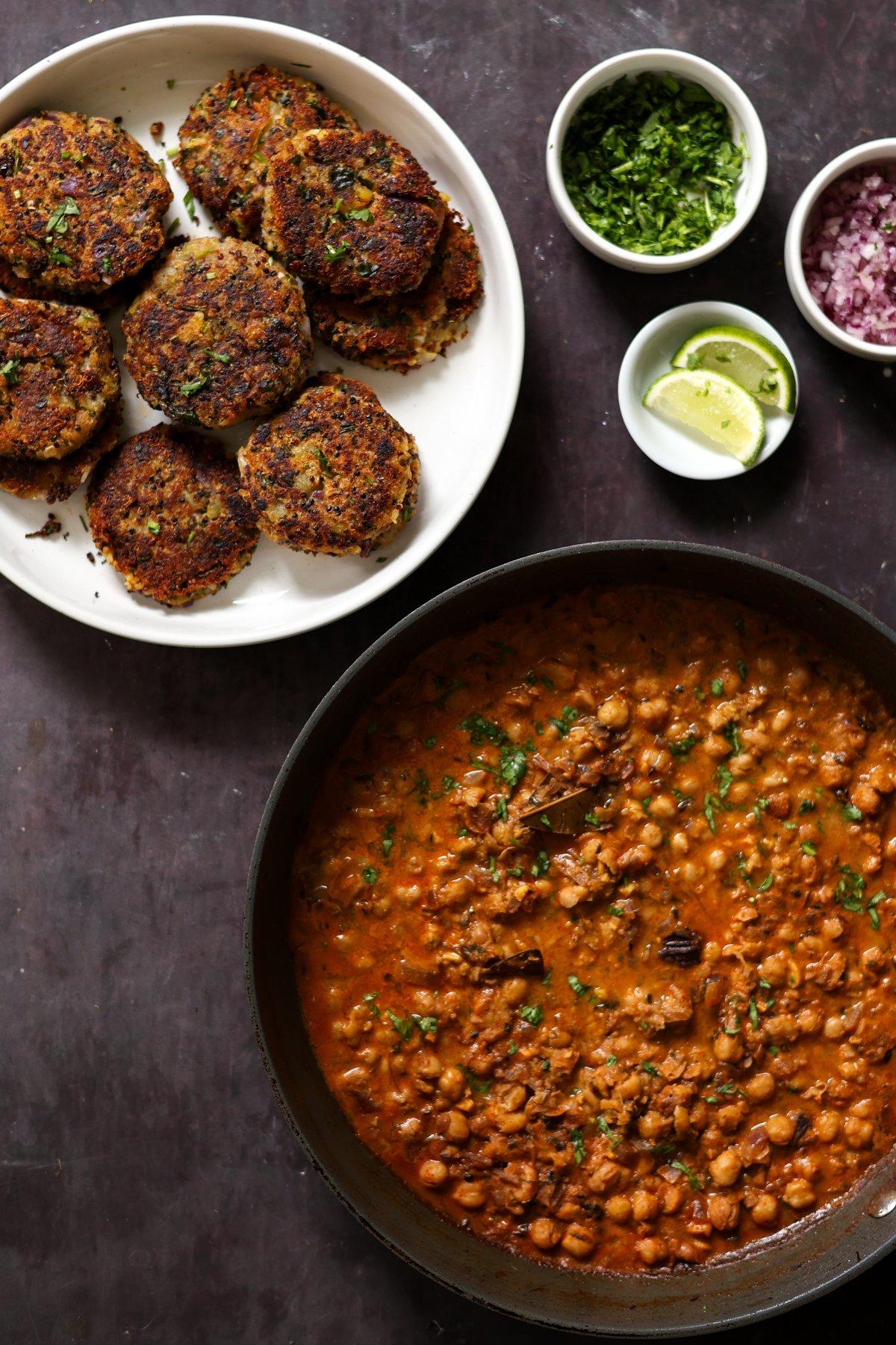 plate of tikkis next to a pan of chole